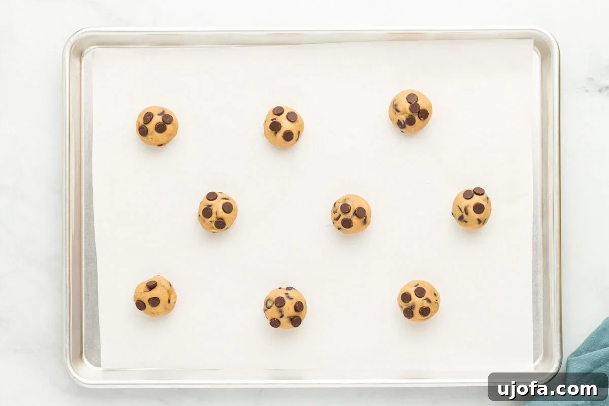 Wholesome Oat Chocolate Chip Treats 12 Balls of oat flour chocolate chip cookie dough spaced out on a baking sheet.