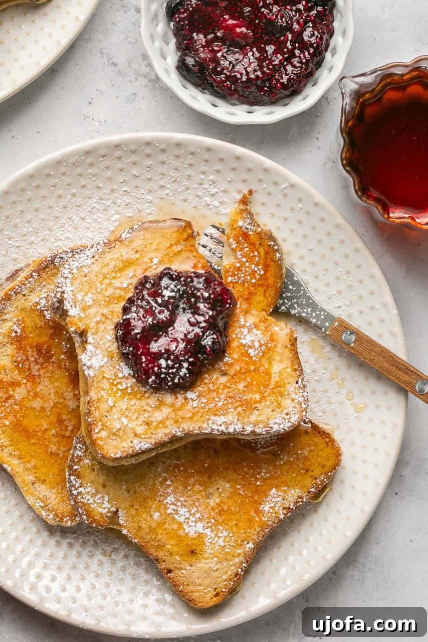 3 slices of french toast on a plate with a fork