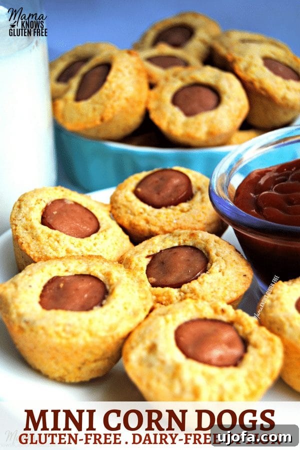 Assortment of gluten-free mini corn dogs arranged on a plate with dipping sauces.