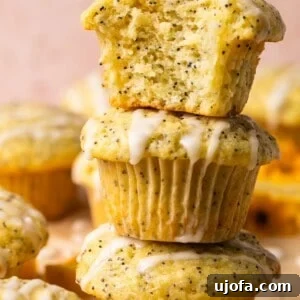 lemon poppyseed muffins stacked on top of each other with a bite taken out of one