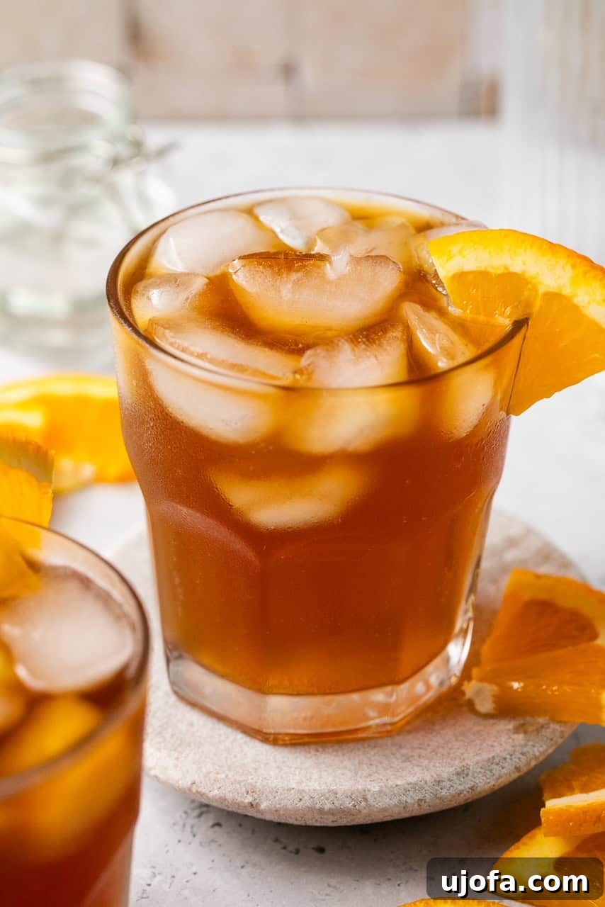 A close-up showing a glass filled with an espresso tonic, highlighting the beautiful layers and condensation