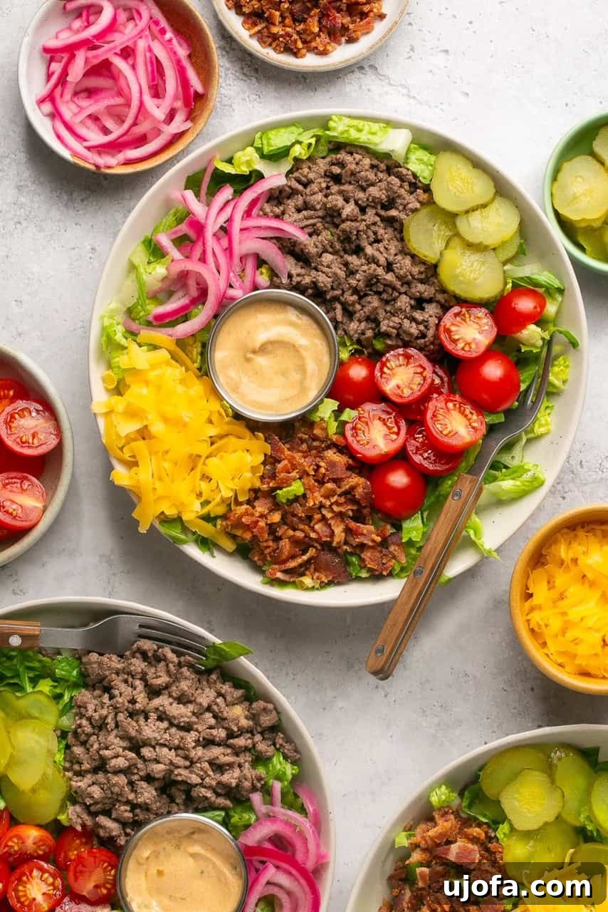 cheeseburger bowls with ground beef, veggies, pickled onions, and Big Mac Sauce surrounded by bowls of toppings