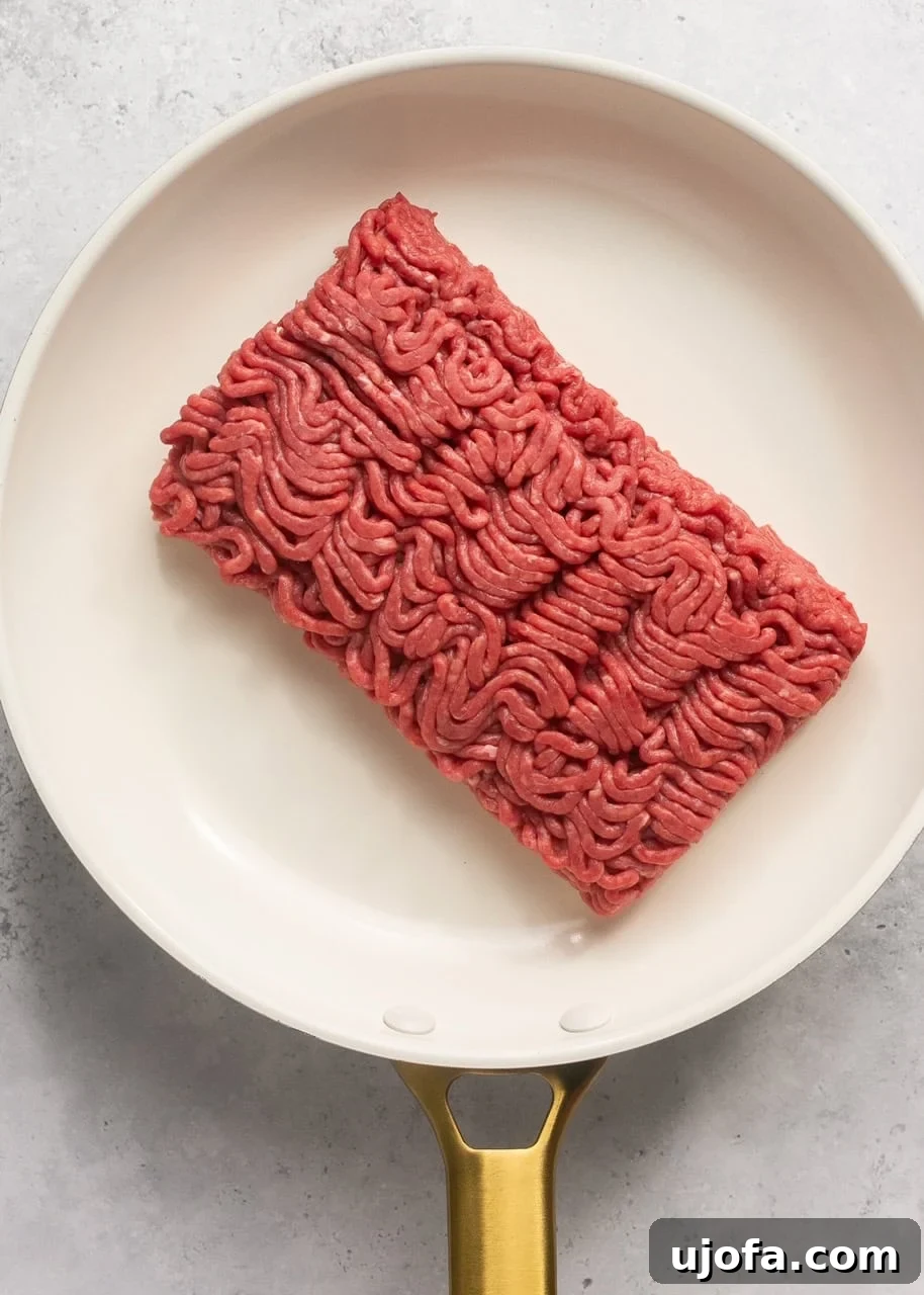 raw ground beef in a skillet