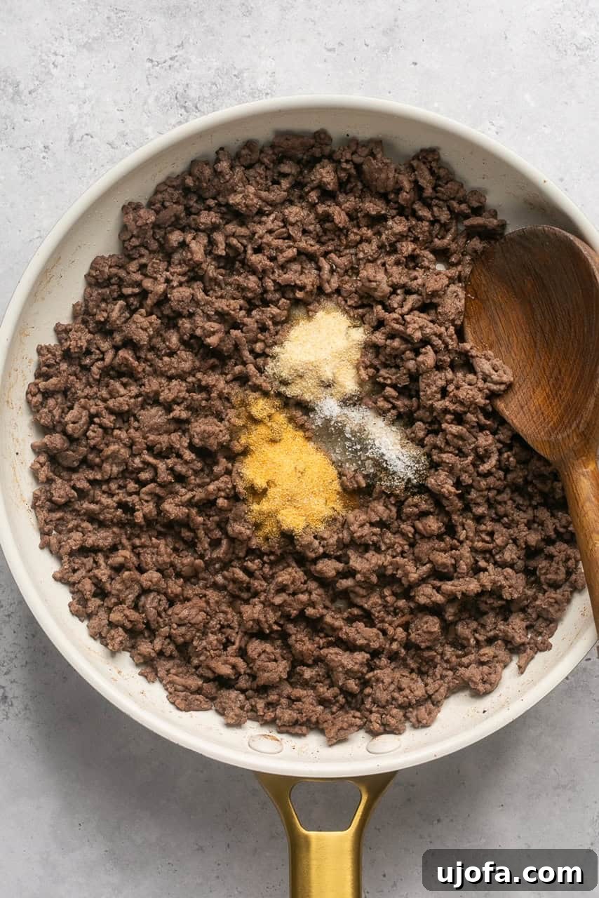 cooked ground beef with seasonings in a skillet