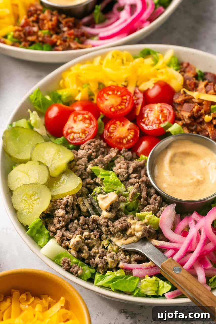 a side view of a cheeseburger bowl with a fork