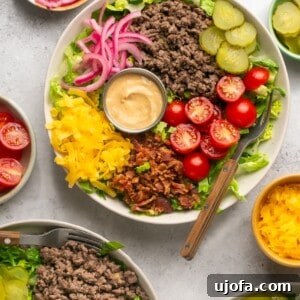 cheeseburger bowls with ground beef, veggies, pickled onions, and Big Mac Sauce surrounded by bowls of toppings