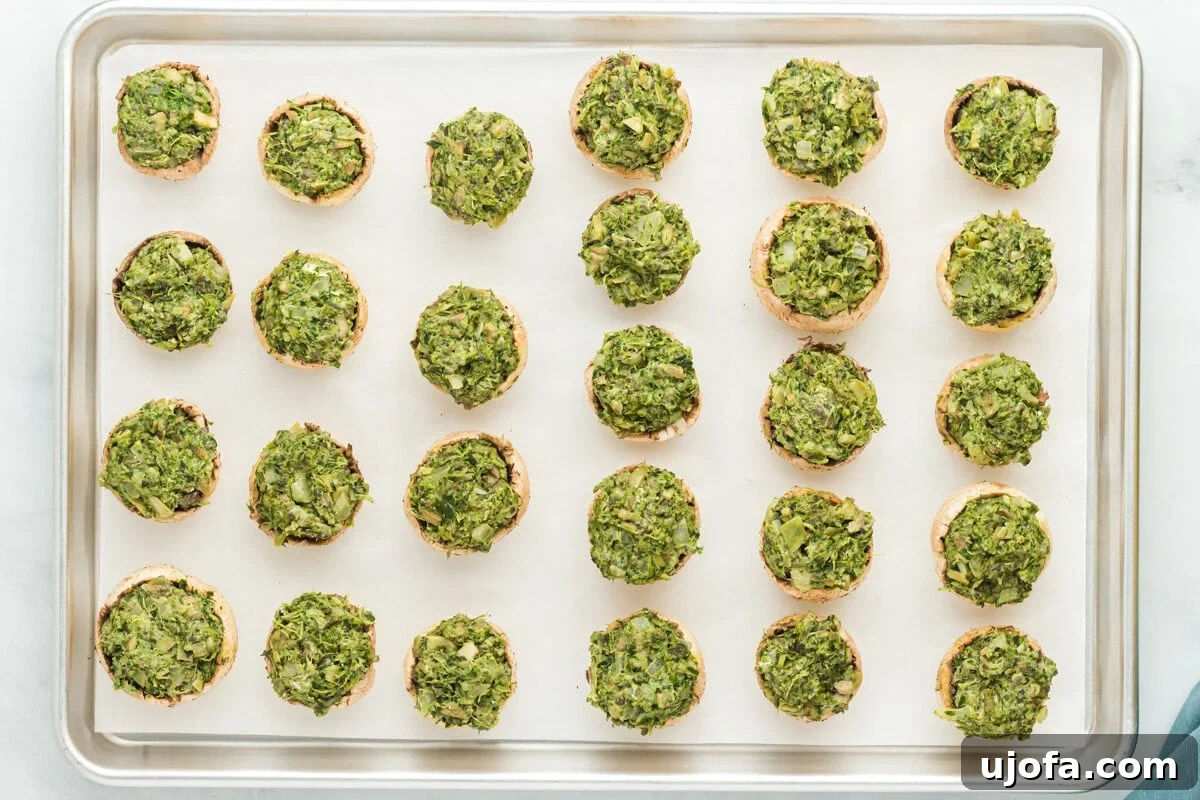Wholesome Mushroom Poppers 14 Stuffed mushrooms on a parchment lined baking sheet