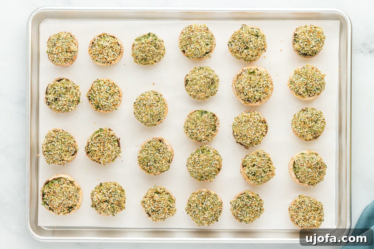 Wholesome Mushroom Poppers 15 gluten-free stuffed mushrooms on a parchment lined baking sheet