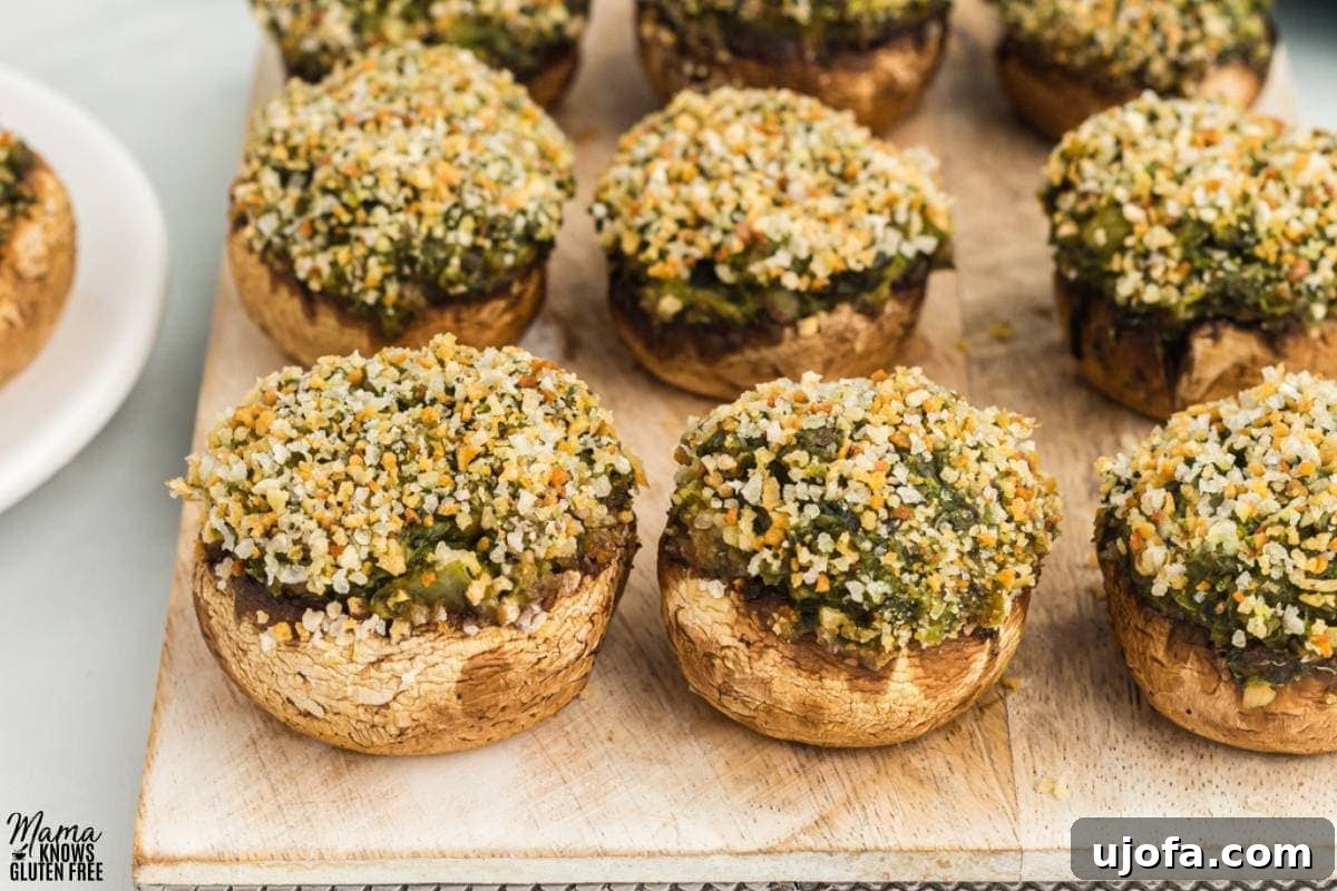 Wholesome Mushroom Poppers 5 gluten-free stuffed mushrooms on a brown cutting board