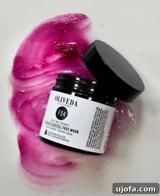 a container of purple face mask open and smeared on a white background
