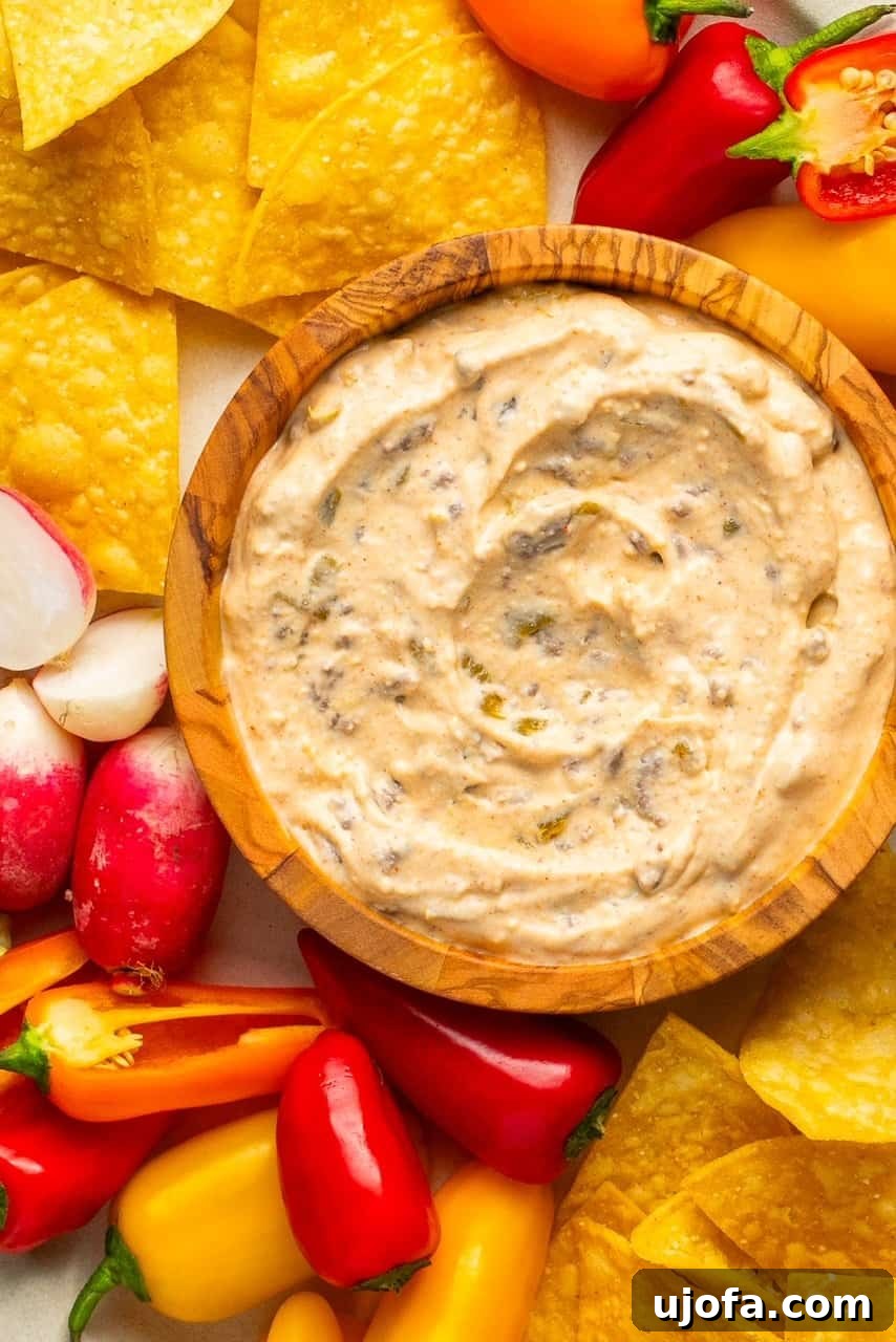 The Viral High-Protein Cottage Cheese Queso: Healthy Dip Perfection 5 a close up shot of cottage cheese queso in a wooden bowl
