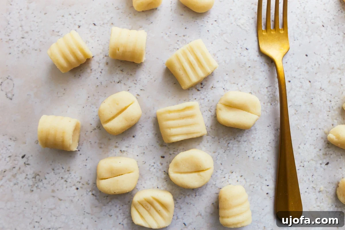 Fluffy Gluten Free Gnocchi 14 ridged gluten free gnocchi next to a fork.