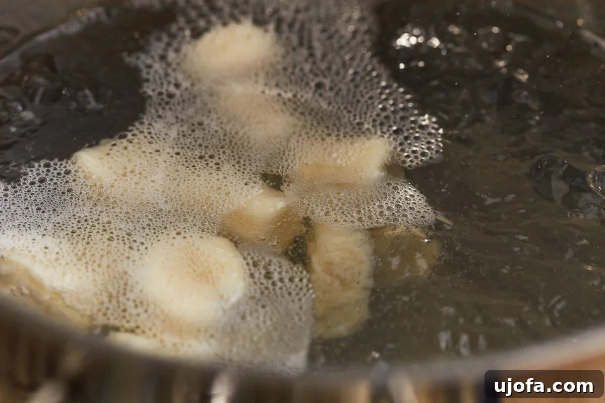 Fluffy Gluten Free Gnocchi 15 gluten free gnocchi boiling in water.