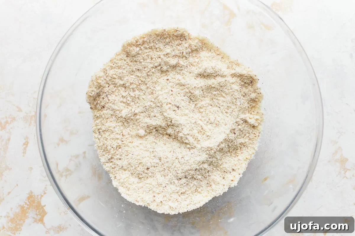 Grain-Free Almond Loaf 4 A glass bowl filled with a perfectly combined mixture of dry ingredients for almond flour bread, including almond flour, tapioca flour, and flaxseed meal, ready for the next step in the baking process.