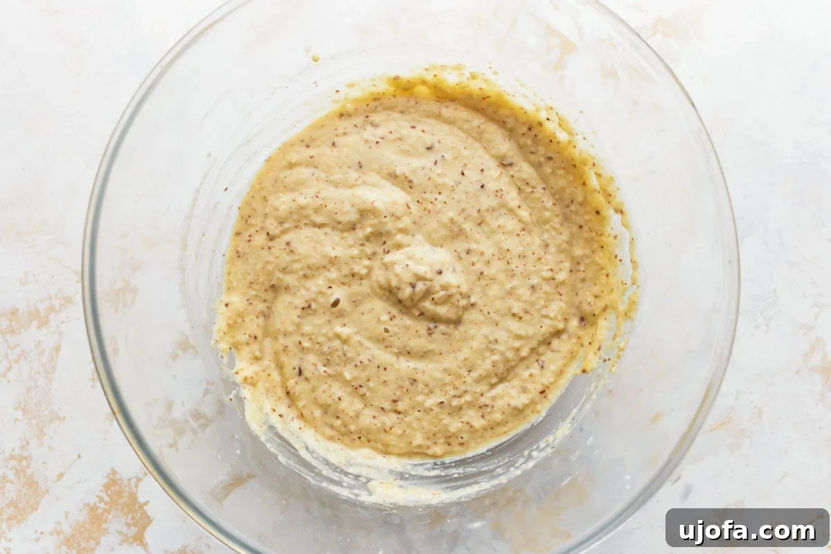 Grain-Free Almond Loaf 6 A close-up view of the smooth, pale almond flour bread batter resting in a clear glass bowl, showcasing its readiness for baking and promising a tender, flavorful loaf.