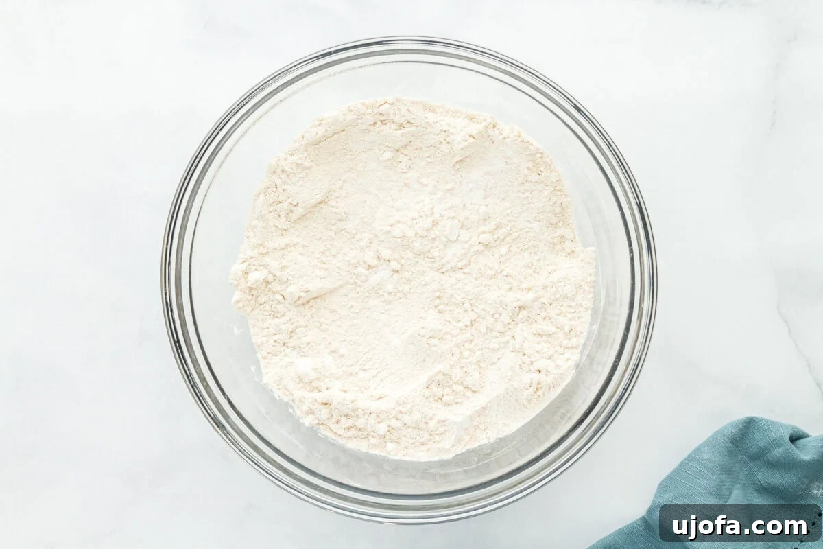The Art of Gluten-Free Sourdough 7 Dry gluten-free flours and salt in a glass bowl, whisked together for sourdough bread.