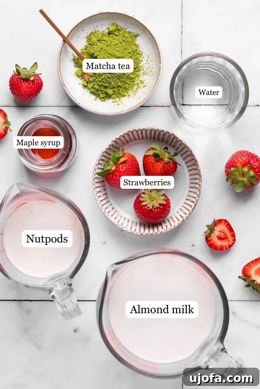 Recipe ingredients laid out in small bowls, including matcha powder, strawberries, milk, and syrup, ready for preparation.