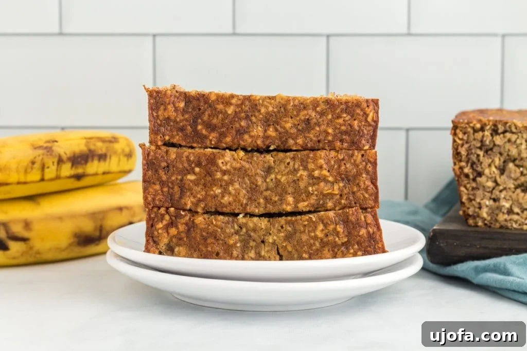 Wholesome Banana Bliss 4 Slices of flourless banana bread arranged artfully on a white plate, highlighting its moist texture.