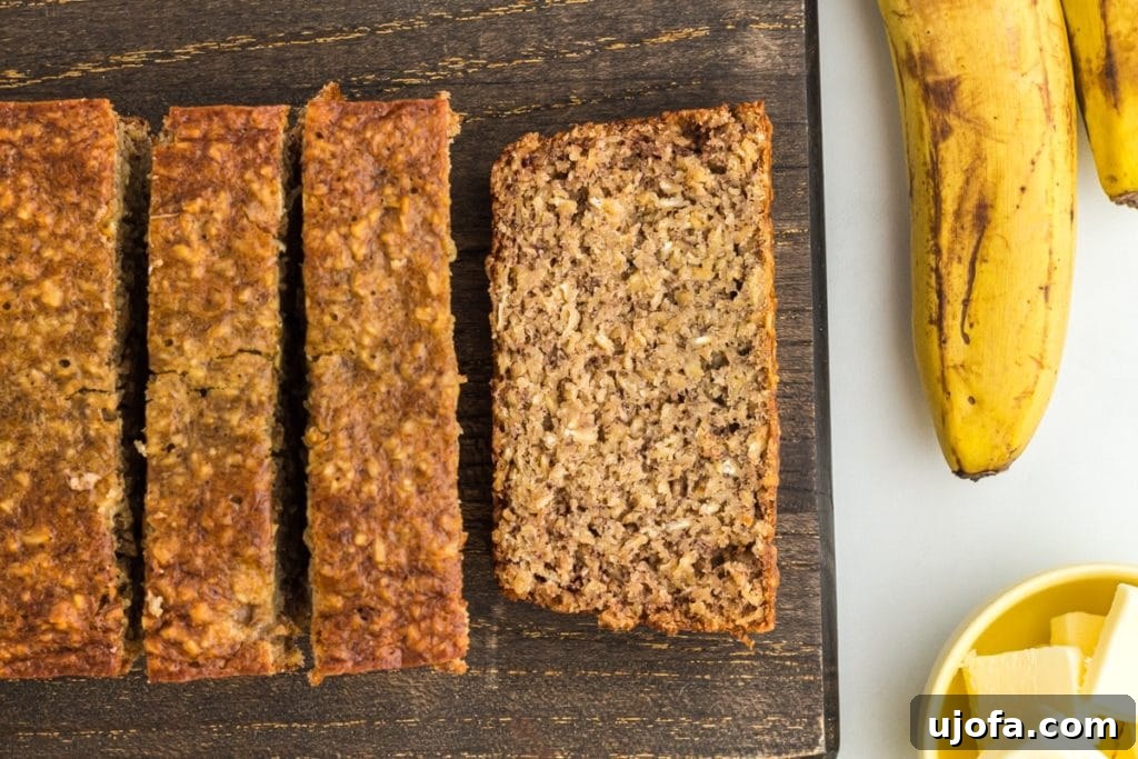 Wholesome Banana Bliss 5 Freshly baked flourless banana bread, expertly sliced on a rustic wooden cutting board.
