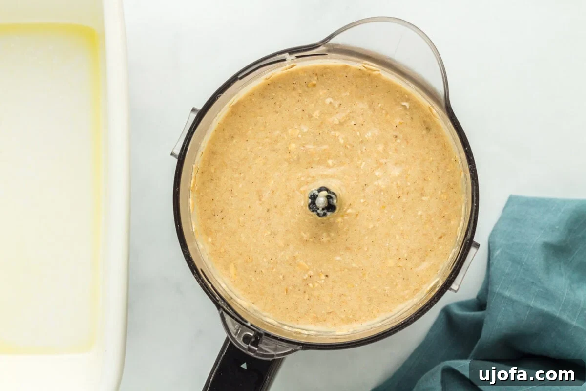 Wholesome Banana Bliss 8 Smooth batter for flourless banana bread in a food processor, after blending.