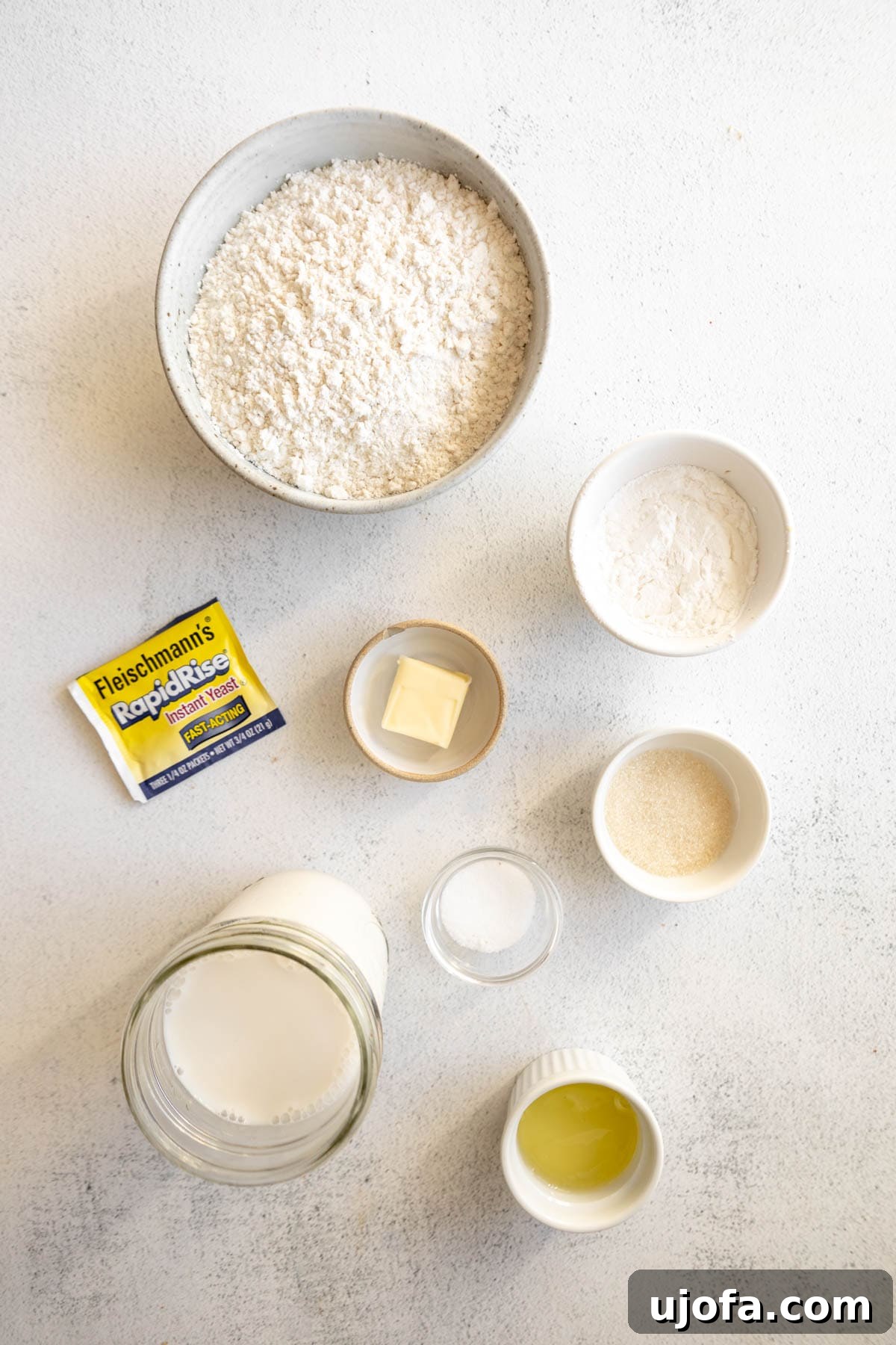 Various gluten-free English muffin ingredients laid out in individual bowls, ready for baking.