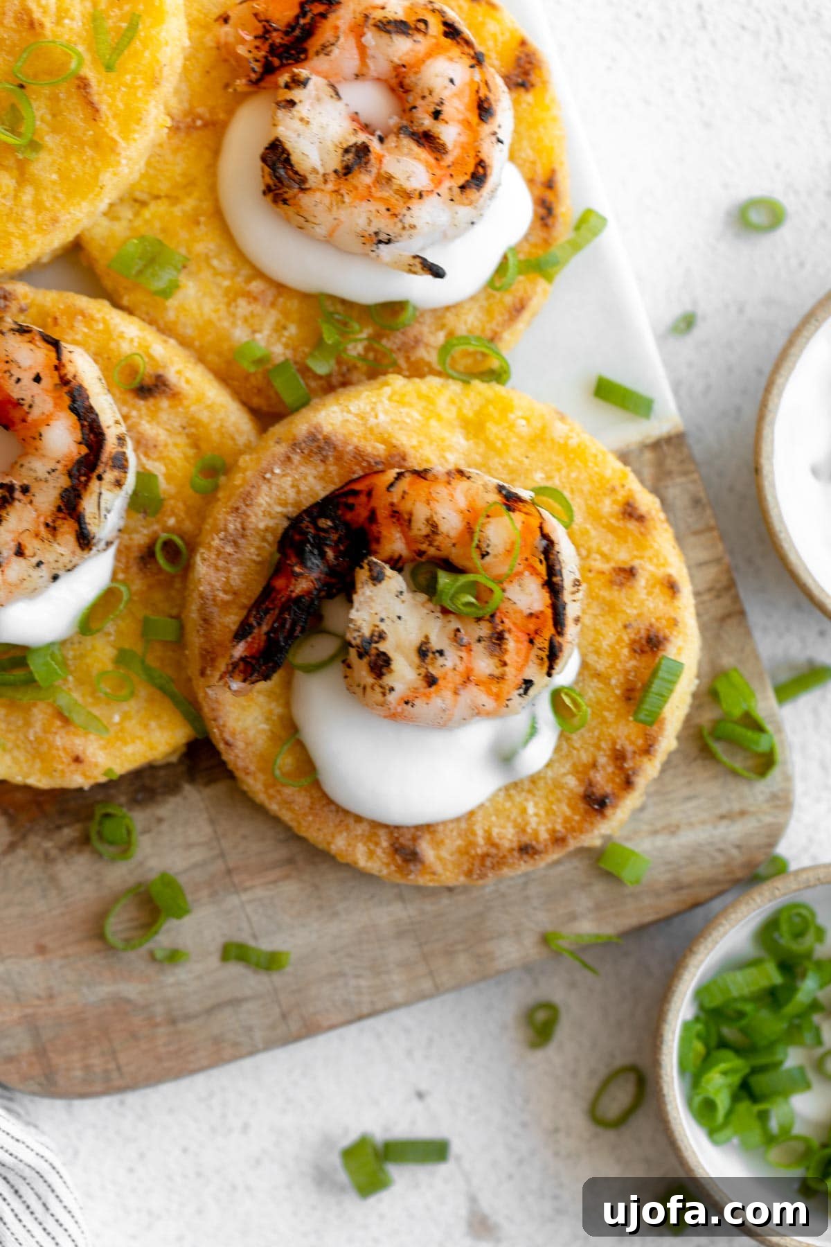 Golden Fried Grits 12 Delicious grit cakes topped with creamy white sauce and fresh shrimp, a gourmet twist on a classic.