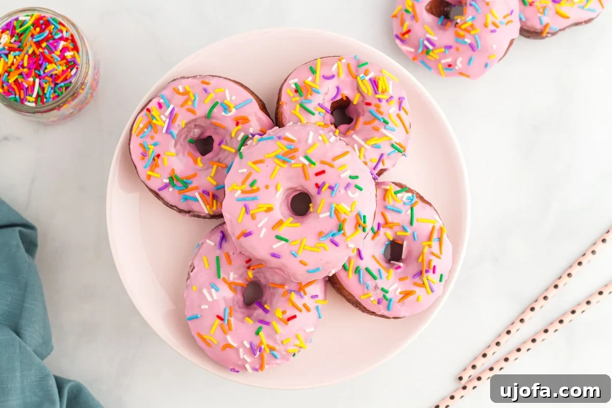 Heavenly Gluten-Free Yeast Donuts 7 Frosted gluten-free yeast donuts arranged beautifully on a white plate, ready to be enjoyed.