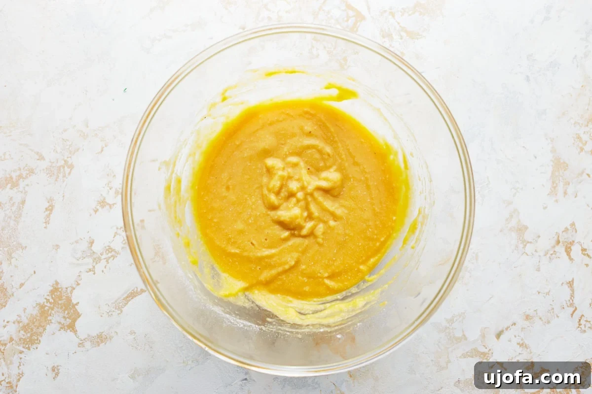 Coconut flour pancake batter in a glass bowl after dry ingredients have been gradually added to the wet, stirred until just combined.