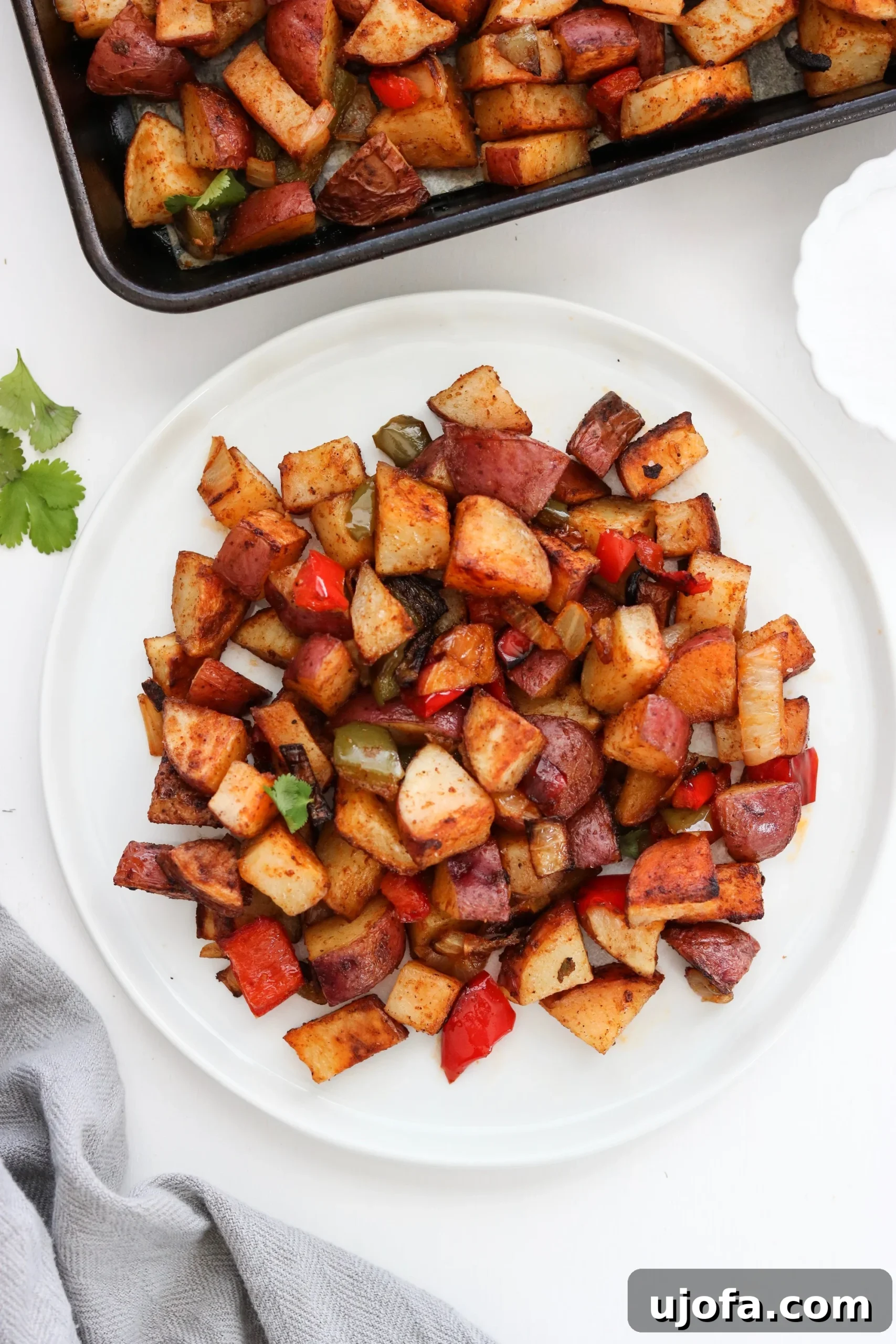 A serving of Sheet Pan Southwest Breakfast Potatoes on a white plate