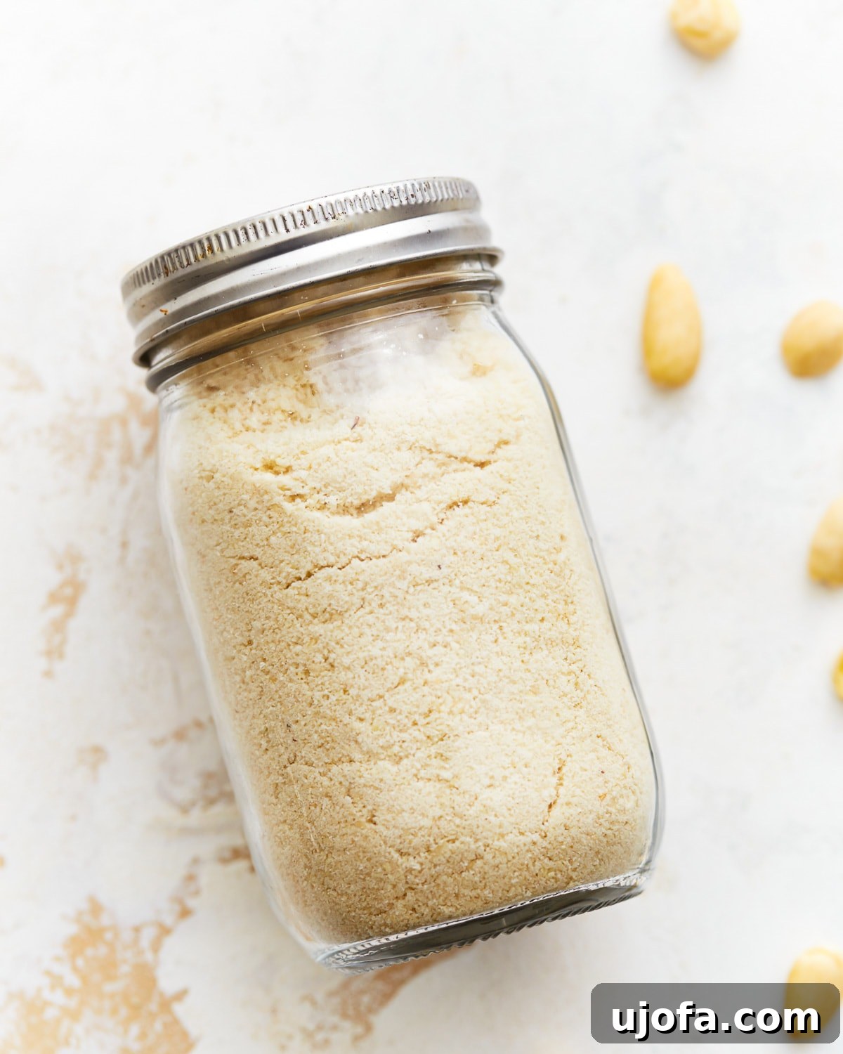 Homemade almond flour stored in a sealed mason jar, ready for future use.