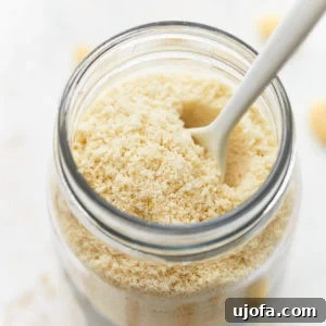 almond flour in a mason jar with a spoon.