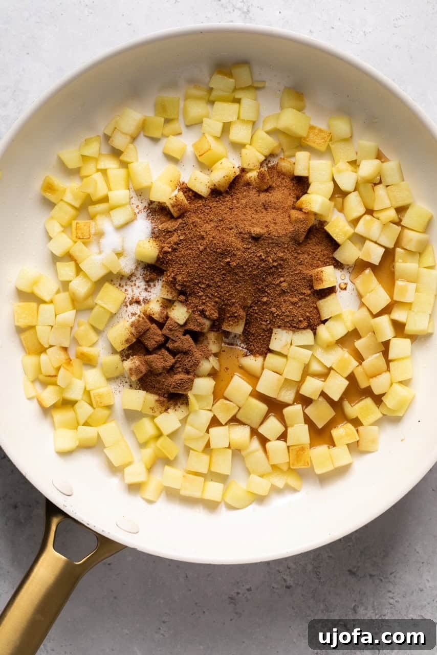 Perfect Caramel Apples Made Simple 6 chopped apples in a skillet with spices