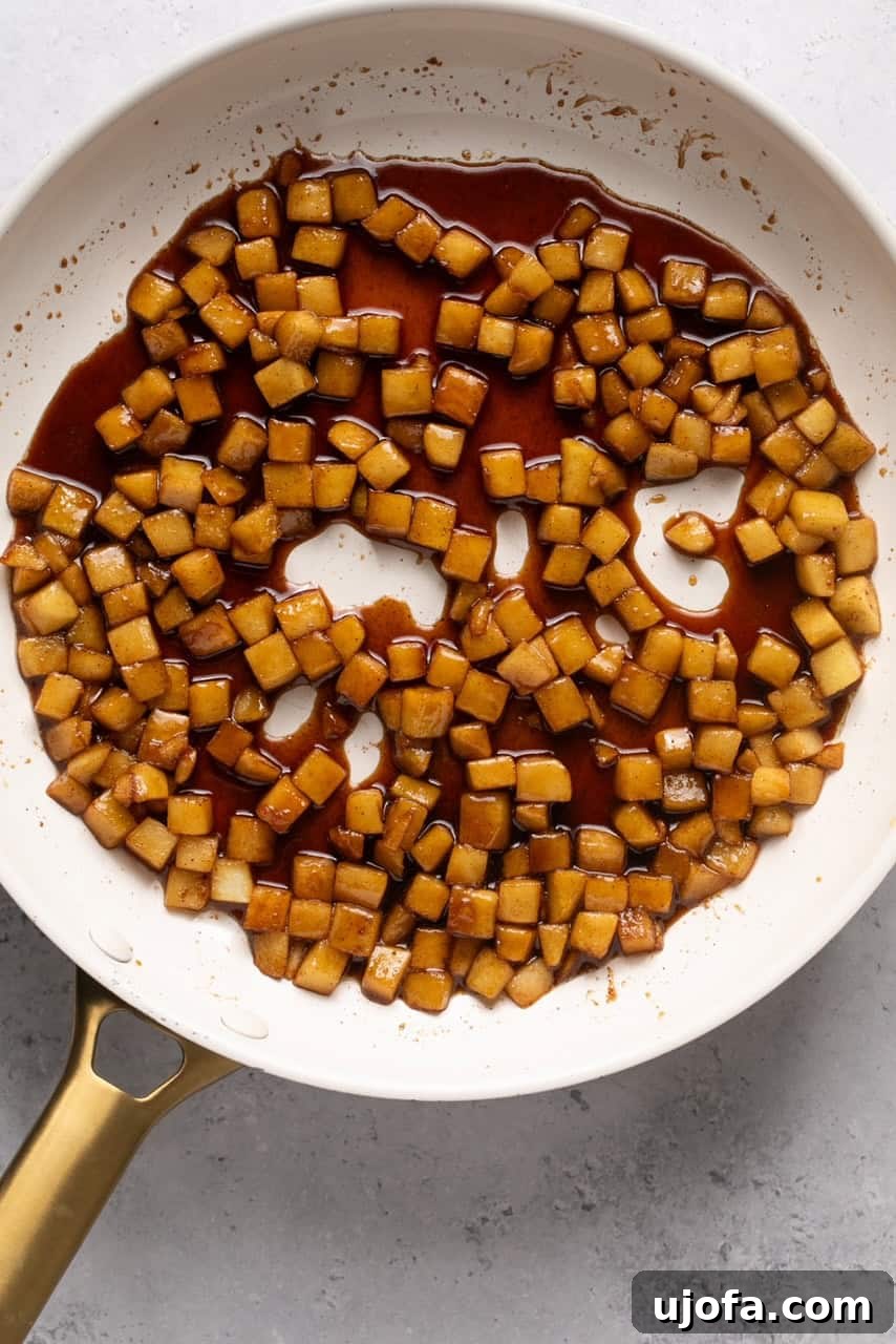 Perfect Caramel Apples Made Simple 7 sauteed apples in a skillet with caramelized sauce