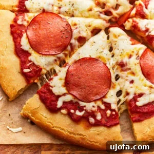 partial overhead view of a sliced gluten-free pepperoni pizza.