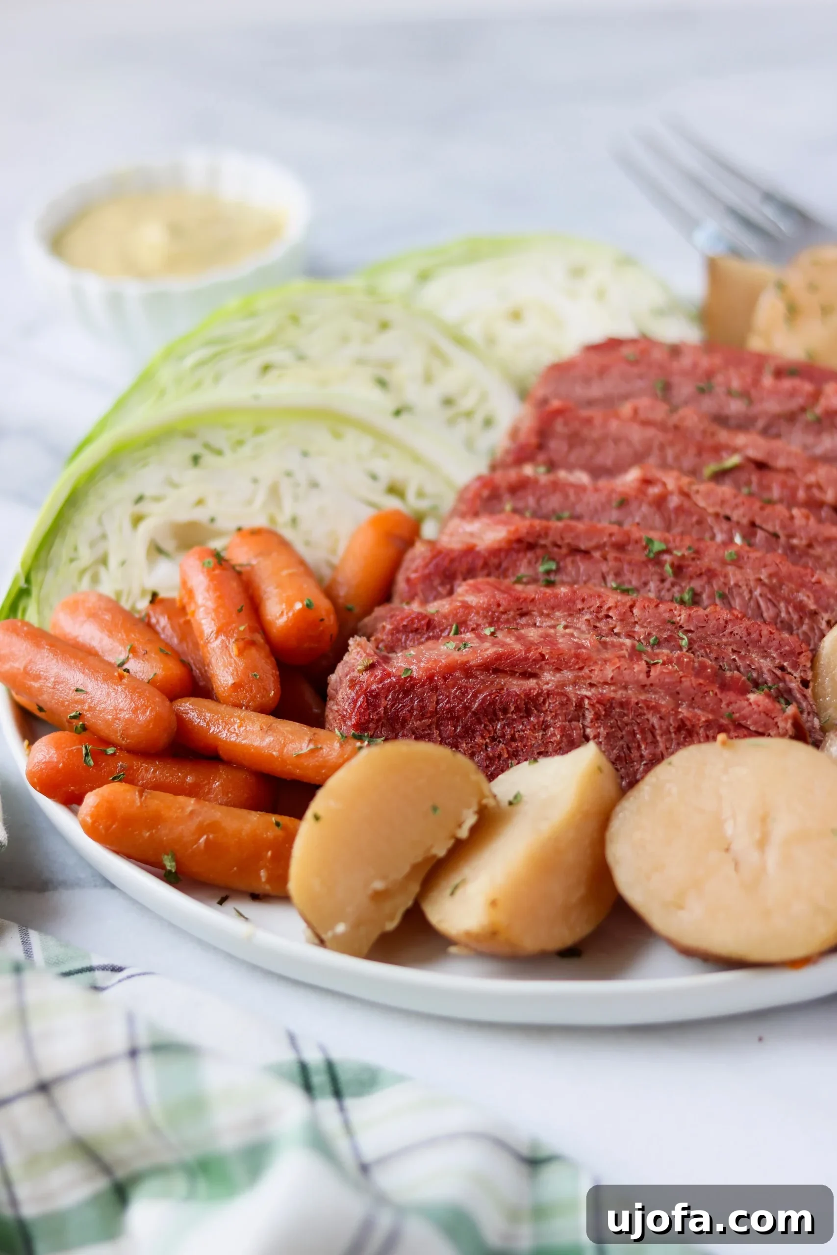 A large cut of raw corned beef brisket resting on a cutting board, ready for the slow cooker.