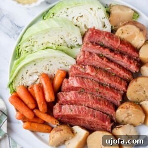 Close-up of Slow Cooker Corned Beef and Cabbage served on a white plate