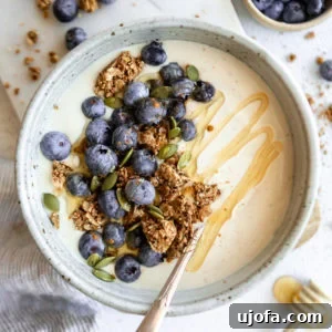 Dairy-free coconut yogurt served in a bowl, garnished with fresh fruit and granola.