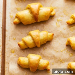 Buttery Gluten-Free Crescent Rolls 3 gluten-free crescent rolls on a baking sheet.