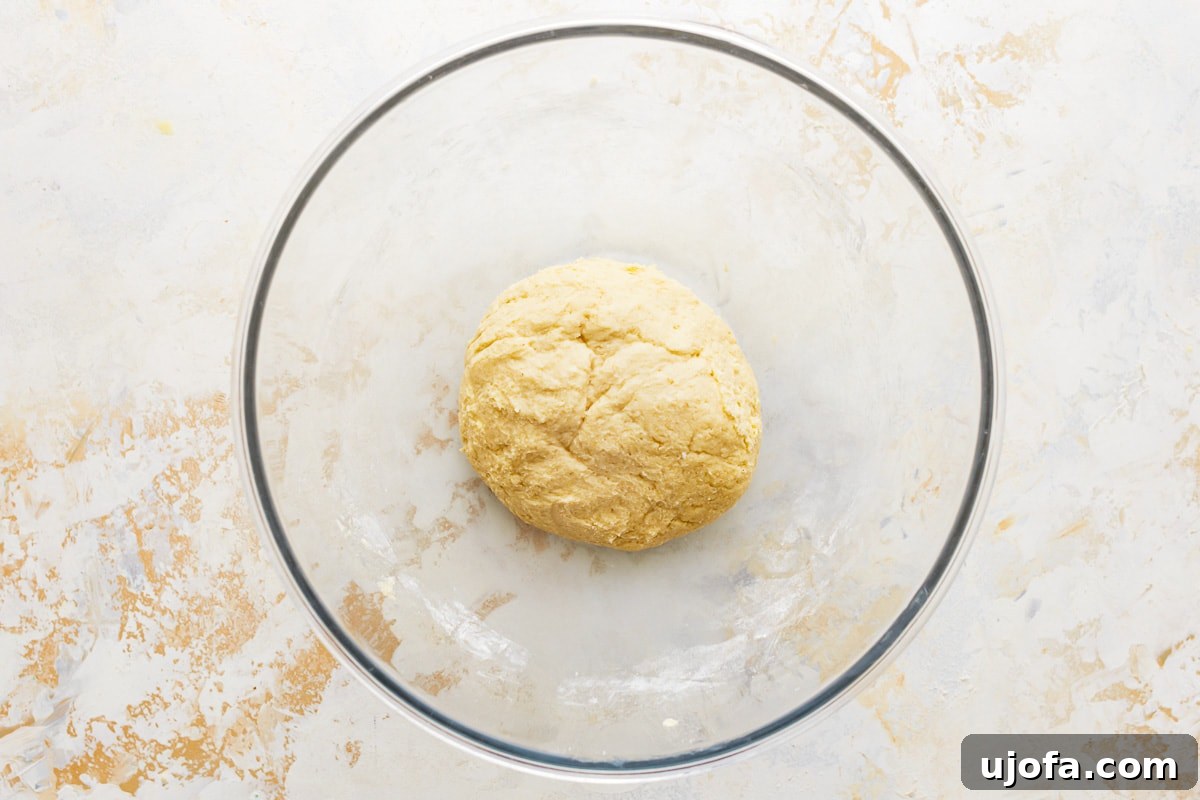 Buttery Gluten-Free Crescent Rolls 7 a glass bowl containing beaten egg and lukewarm milk, whisked together.