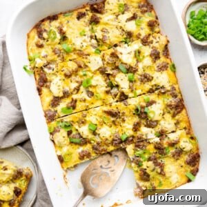 Sausage Hash brown casserole with green onions sliced in a white Staub casserole dish