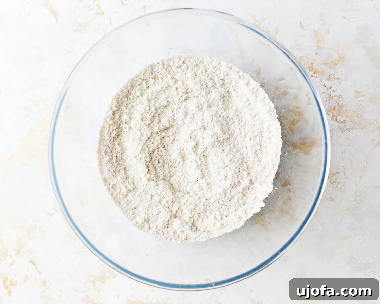 Mixed Dry Ingredients Dry ingredients for gluten-free vanilla cake in a glass mixing bowl.