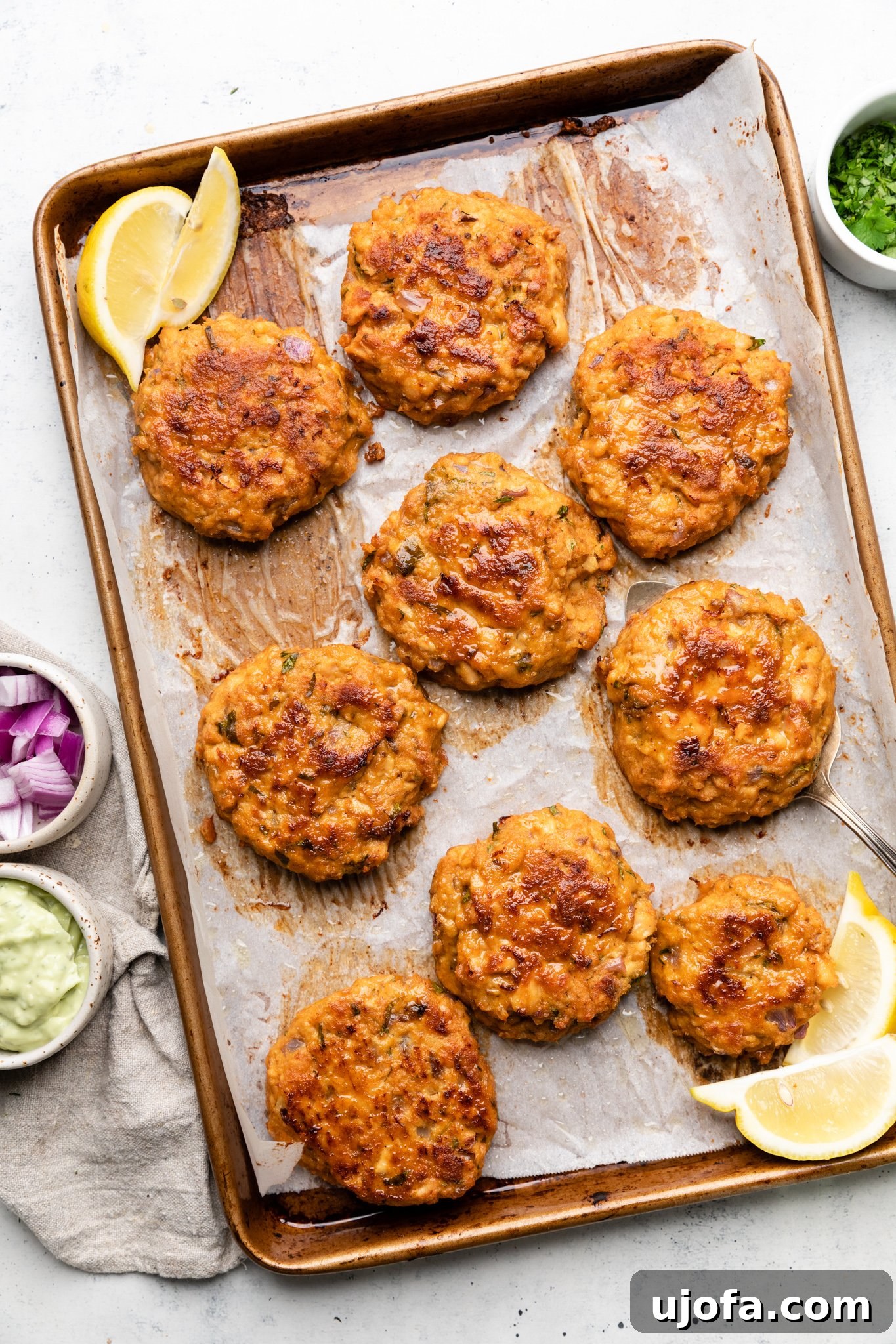 Keto Southwest Salmon Cakes with Cool Avocado Crema 5 Baked salmon patties on a baking sheet