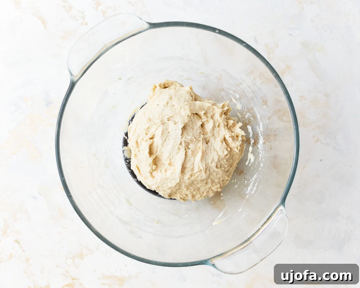 Gluten-free baguette dough in a glass mixing bowl.