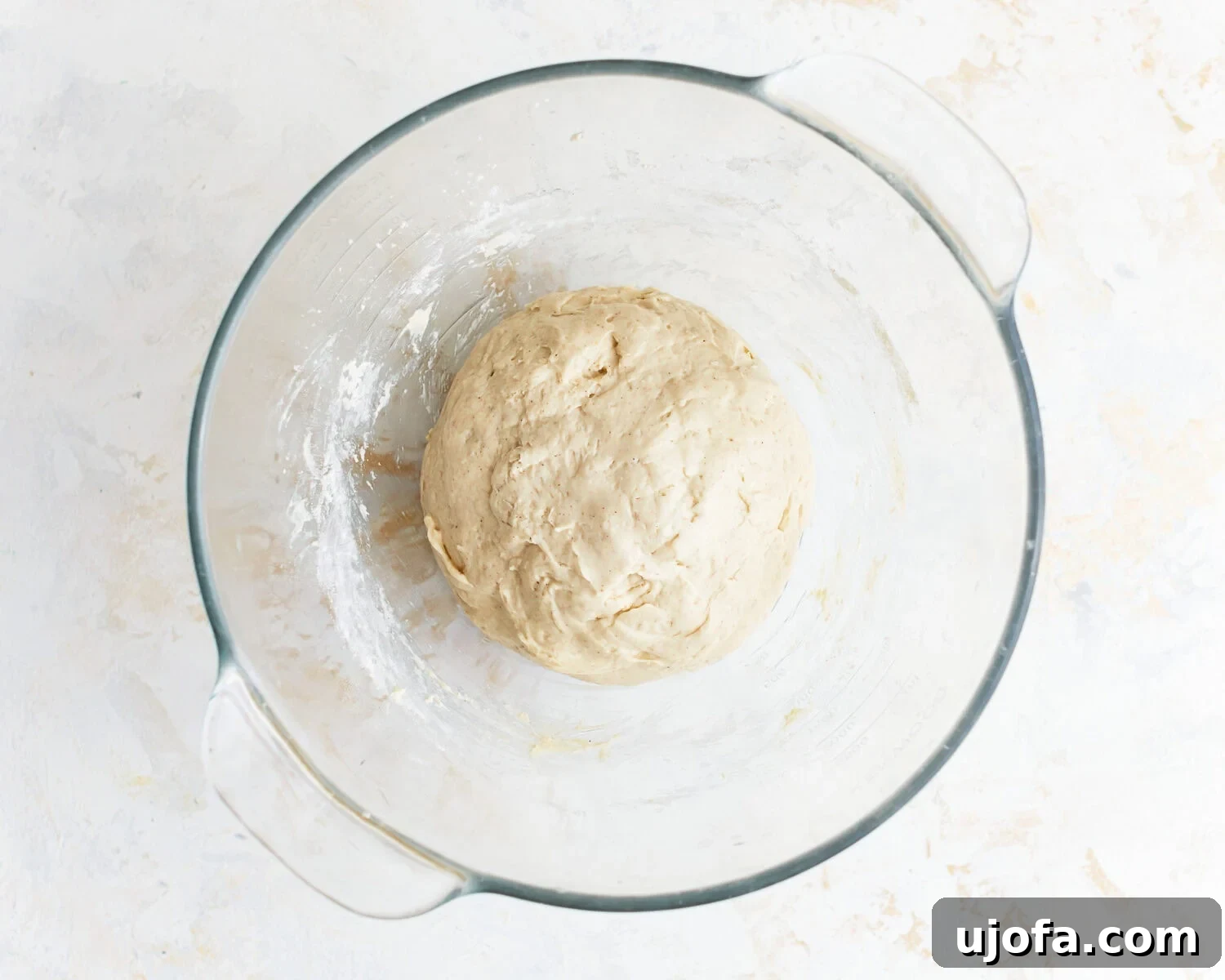 Gluten-free baguette dough in a glass mixing bowl.