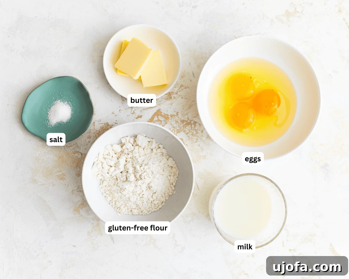 Gluten-free dutch baby ingredients laid out on a kitchen counter: eggs, milk, gluten-free flour, salt, and butter.