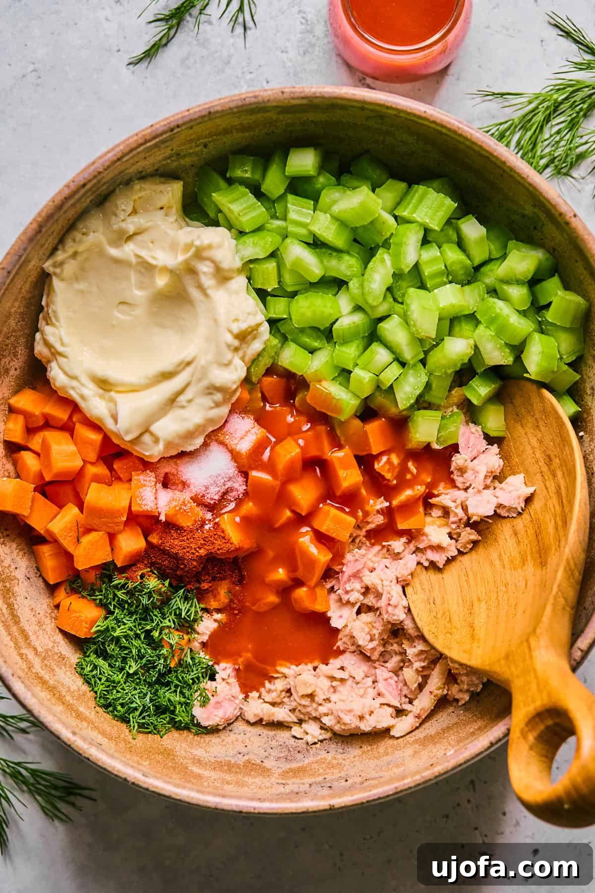 All ingredients for buffalo tuna salad placed in a mixing bowl before combining