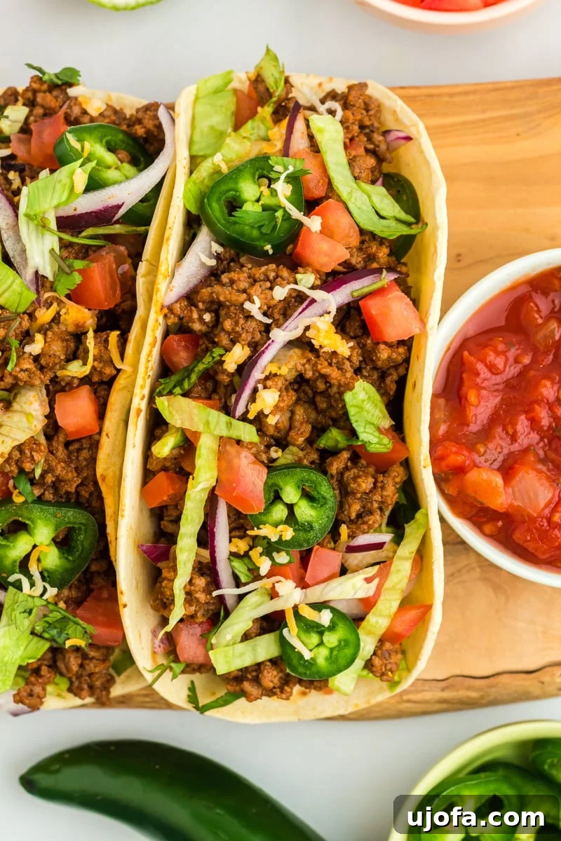 Guilt-Free Taco Night 5 close up view of gluten-free tacos on a wooden cutting board.