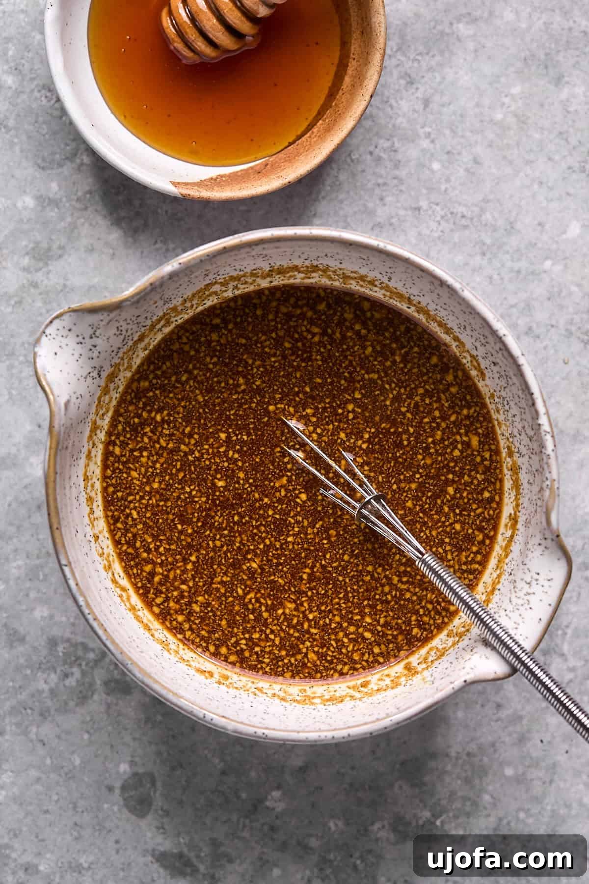 Smooth, whisked hot honey sauce in a bowl, ready for cooking.