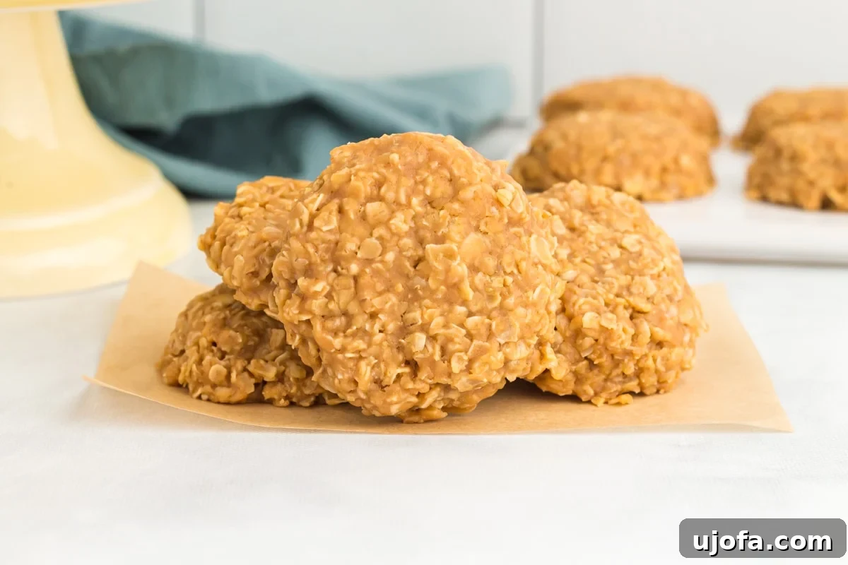 Easy Peanut Butter No-Bake Cookies 6 Four perfectly formed no-bake peanut butter cookies arranged neatly on a piece of parchment paper, ready to be enjoyed.