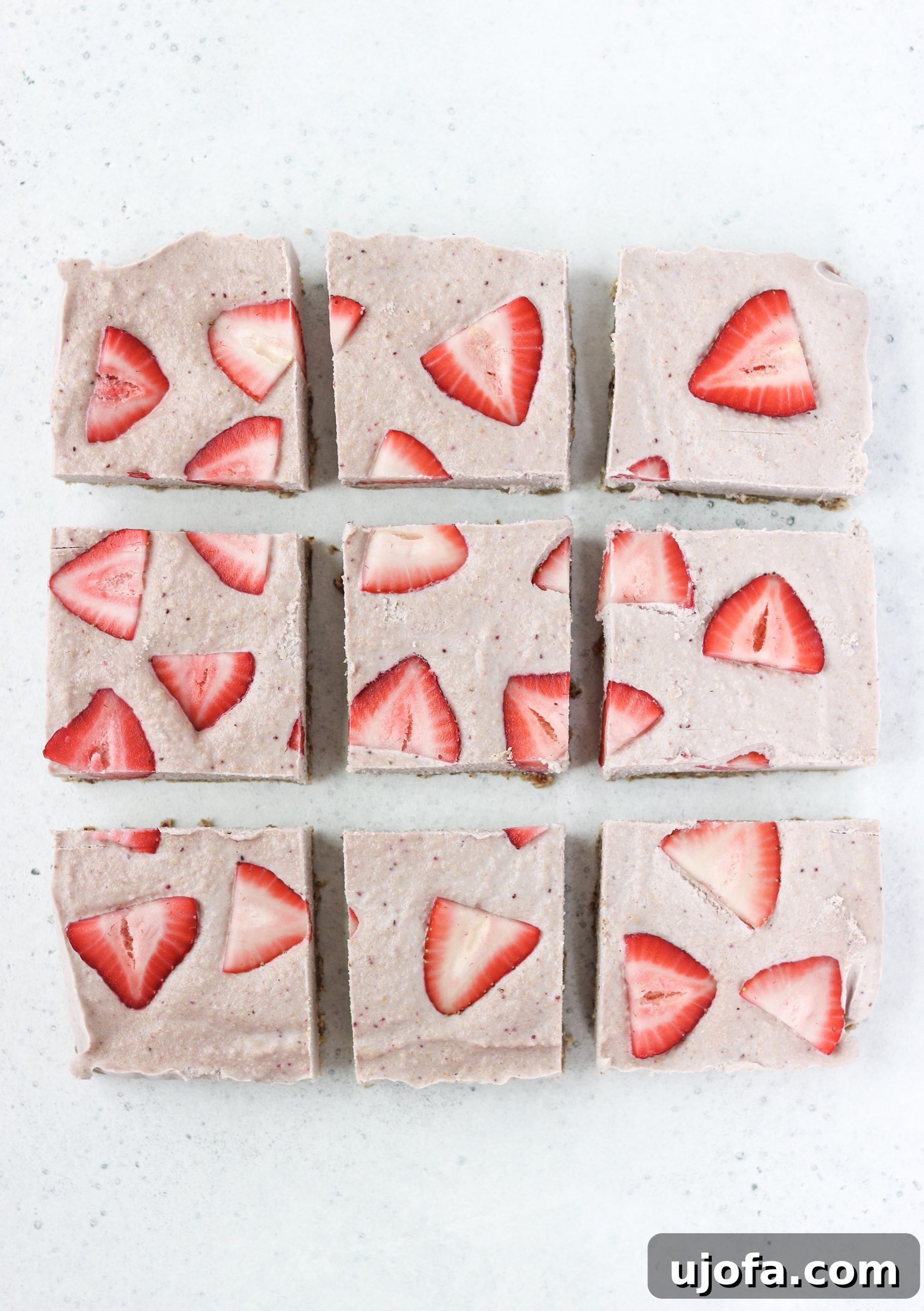 Paleo No-Bake Strawberry Cheesecake Delights 6 Finished Vegan & Paleo No-Bake Strawberry Cheesecake Bars ready to serve